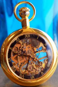 A gold pocket watch with roman numerals and a blue background.