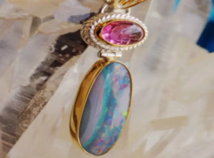 A necklace with two different colored stones on it.