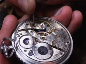 A person working on an old watch