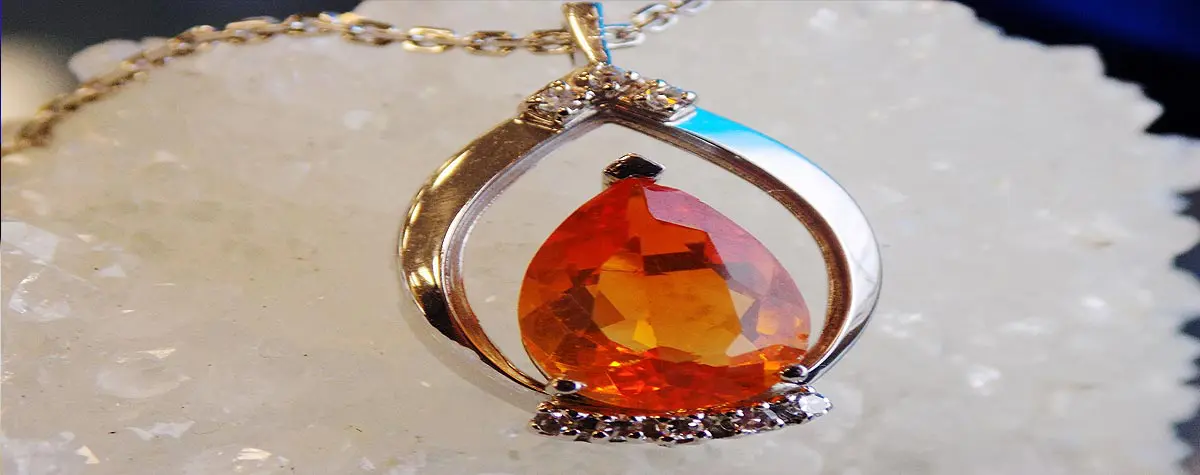 A necklace with an orange stone on it