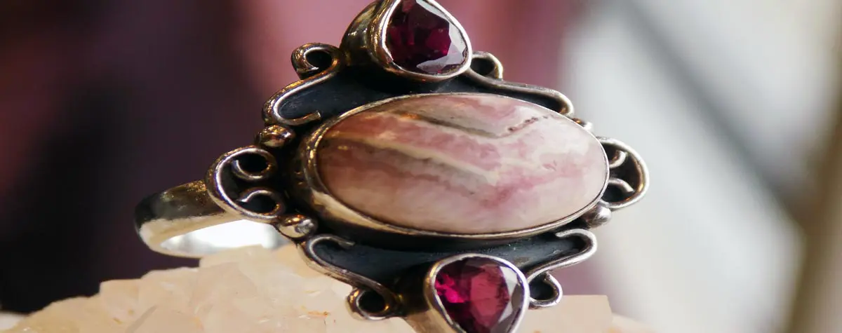 A ring with two red stones on it.