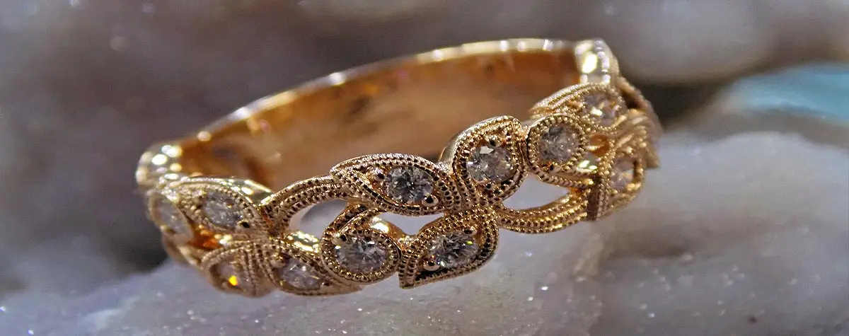 A gold ring with diamonds on top of it.