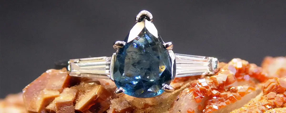 A close up of a ring with a blue stone