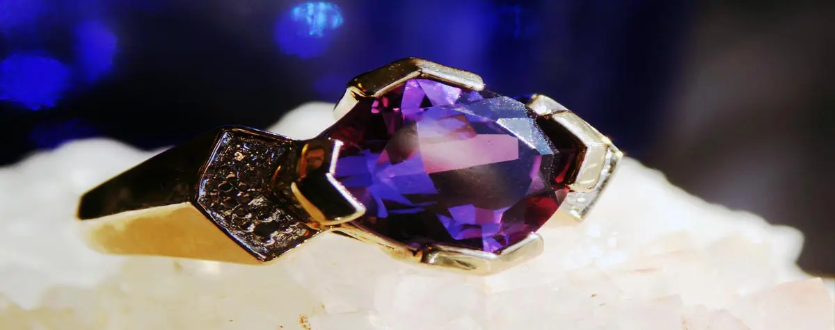 A purple stone is sitting on top of a white surface.