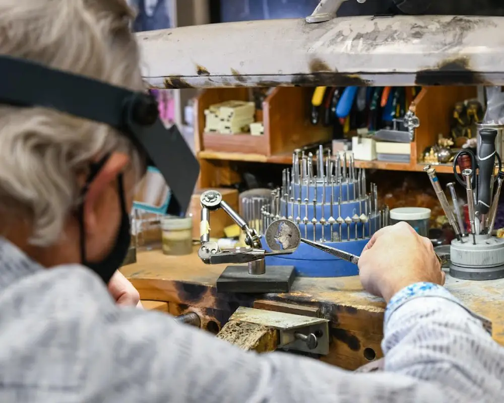 A man working on some kind of object in his shop