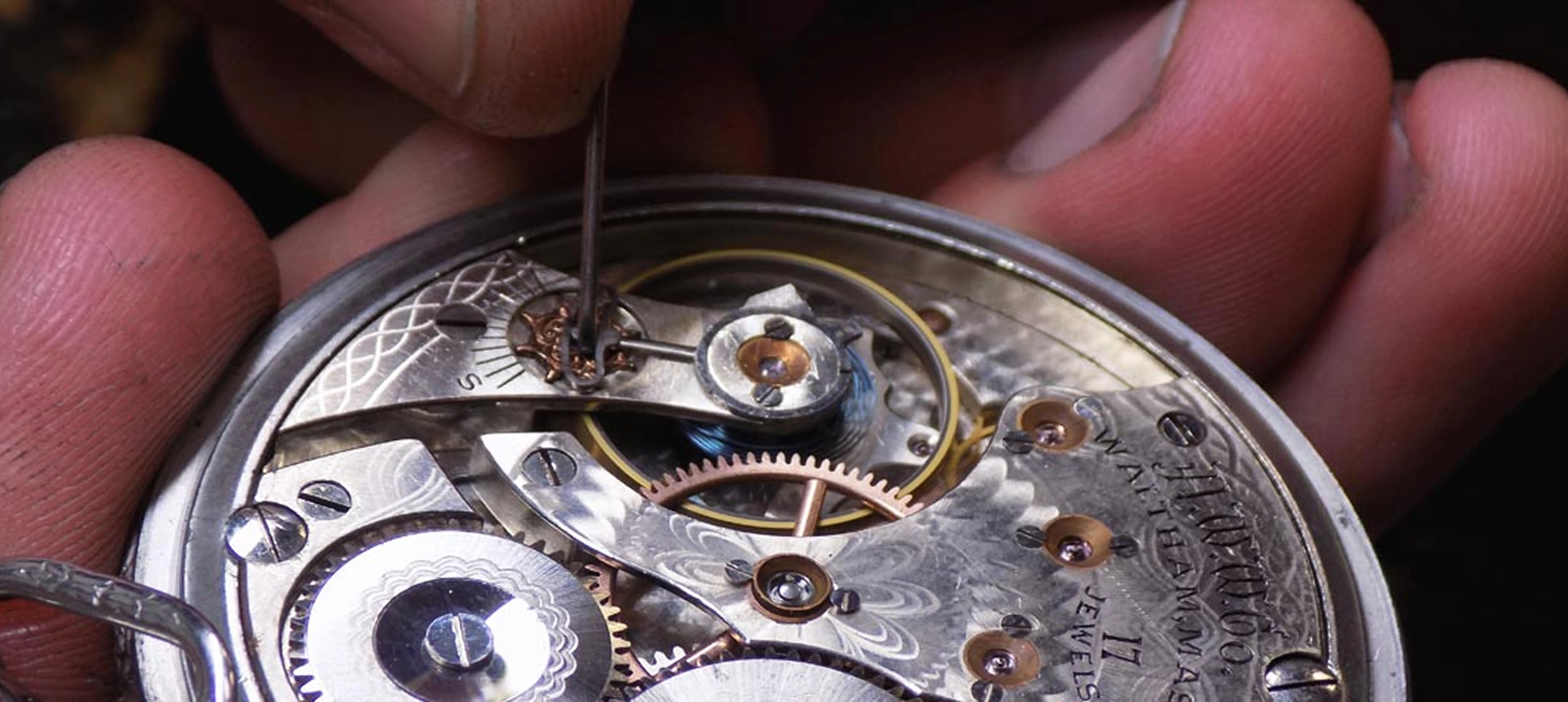 Watchmaker repairing a mechanical watch movement