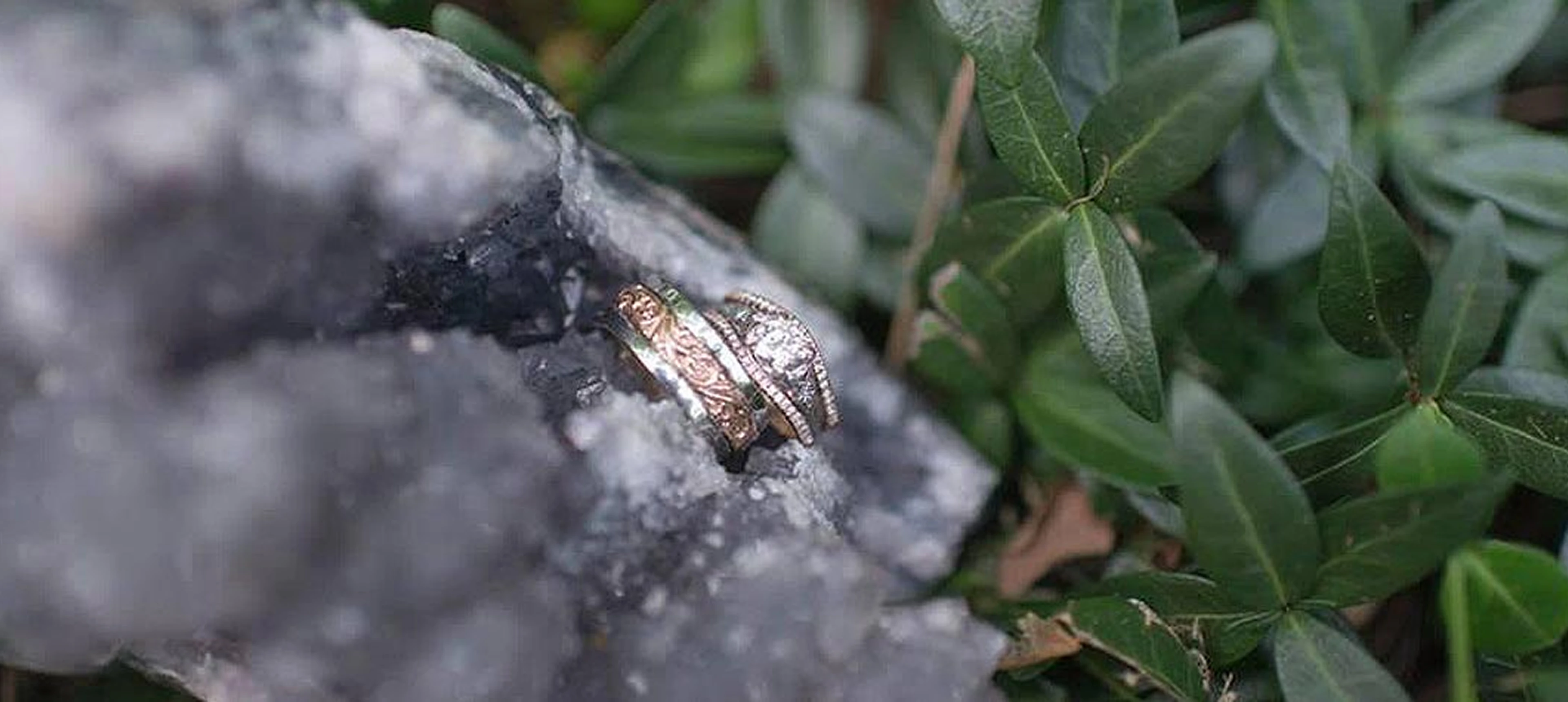 Elegant rings resting on textured rock surface
