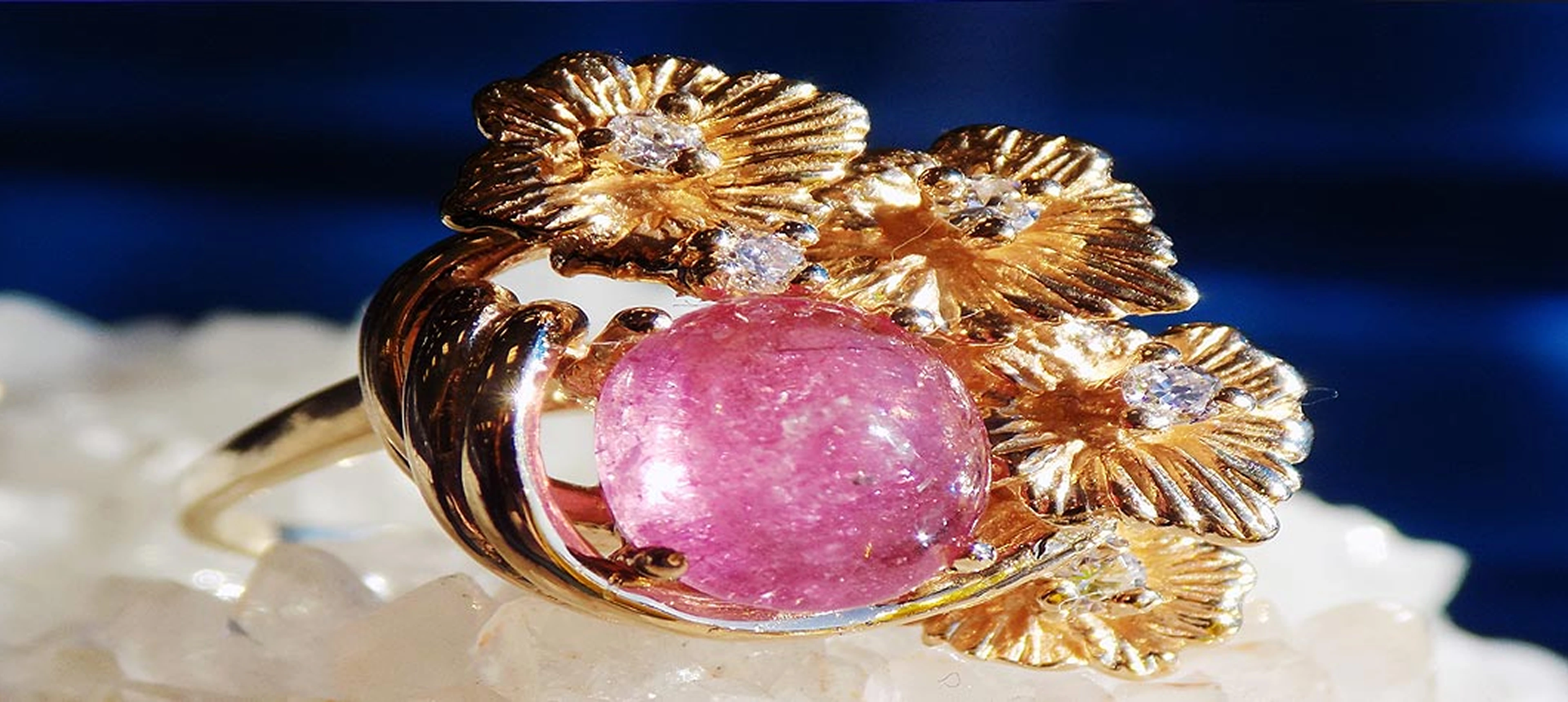 Pink stone in gold floral setting